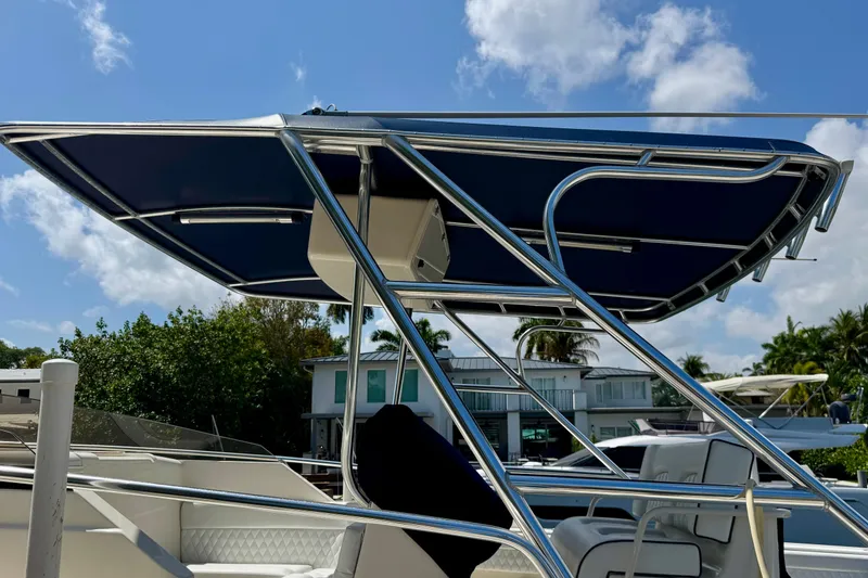 Slide: The Image of 2001 Intrepid 339 Walkaround boat with blue canopy and sleek design. - 51