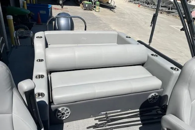 Slide: The Image of 2020 Manitou 25 OASIS SL VP pontoon boat interior with gray seating and cup holders. - 18