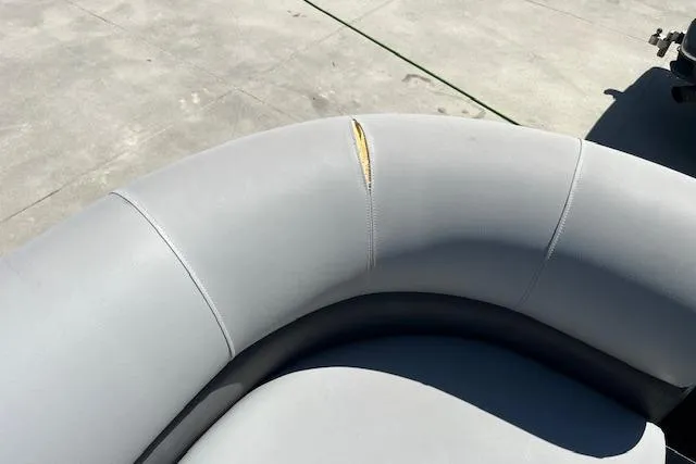Slide: The Image of Torn upholstery on 2020 Manitou 25 OASIS SL VP boat seat, showing visible damage. - 8
