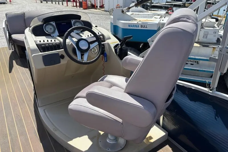 Slide: The Image of 2020 Godfrey Sweetwater 2286 FS boat helm with steering wheel and captain's chair. - 6