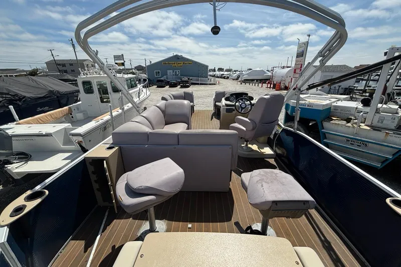 Slide: The Image of 2020 Godfrey Sweetwater 2286 FS pontoon boat interior with seating and steering console. - 10