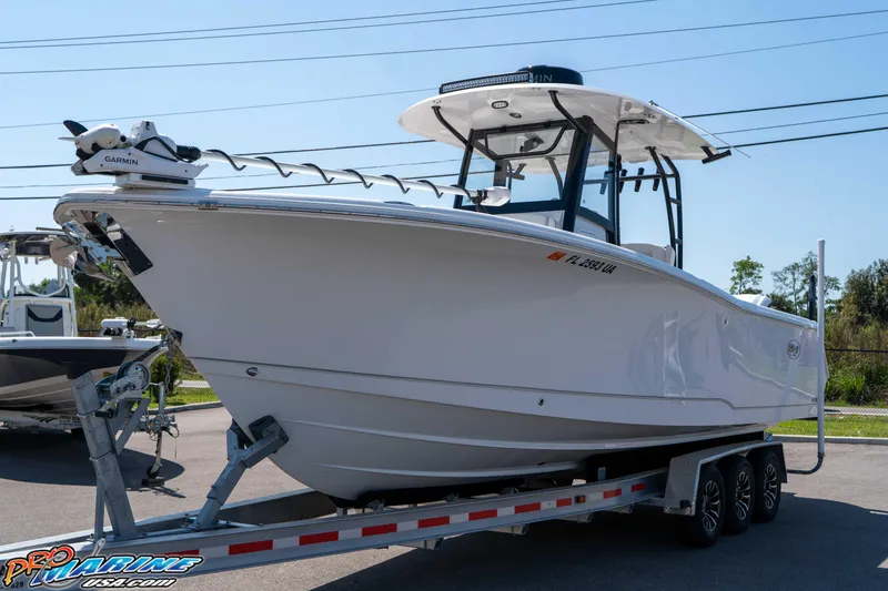 Slide: The Image of 2025 Sea Hunt Gamefish 28 Forward Seating boat on trailer, featuring Garmin equipment. - 10