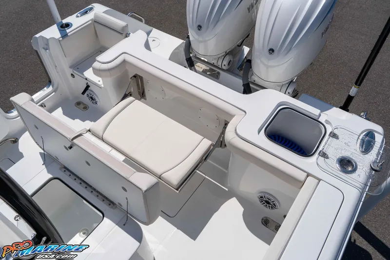 Slide: The Image of 2025 Sea Hunt Gamefish 28 boat interior with seating, storage, and dual engines. - 13