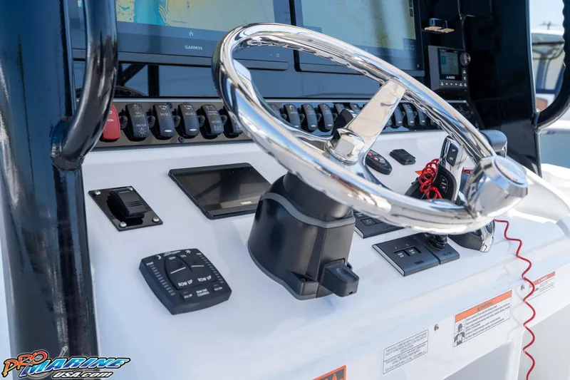 Slide: The Image of 2025 Sea Hunt Gamefish 28 helm with advanced controls and Garmin navigation system. - 19
