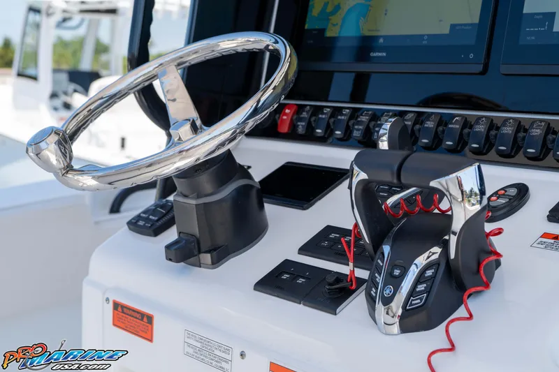 Slide: The Image of 2025 Sea Hunt Gamefish 28 helm with advanced controls and navigation display. - 20