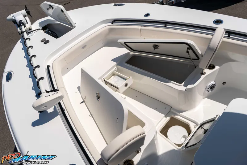 Slide: The Image of 2025 Sea Hunt Gamefish 28 Forward Seating boat interior with storage compartments open. - 23