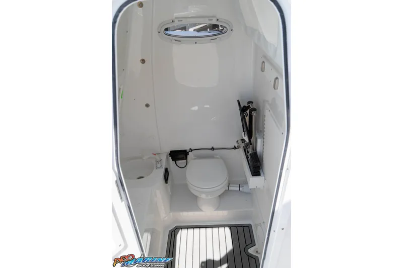 Slide: The Image of Interior view of 2025 Sea Hunt Gamefish 28 Forward Seating boat's compact bathroom. - 27