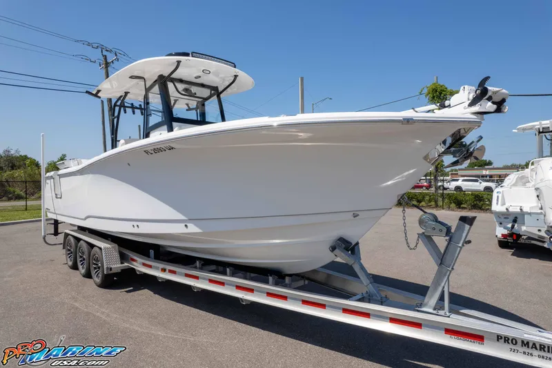 Slide: The Image of 2025 Sea Hunt Gamefish 28 Forward Seating boat on trailer in parking lot. - 29
