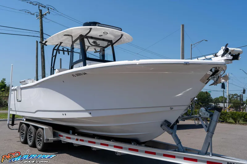 Slide: The Image of 2025 Sea Hunt Gamefish 28 Forward Seating boat on trailer, displayed outdoors. - 3