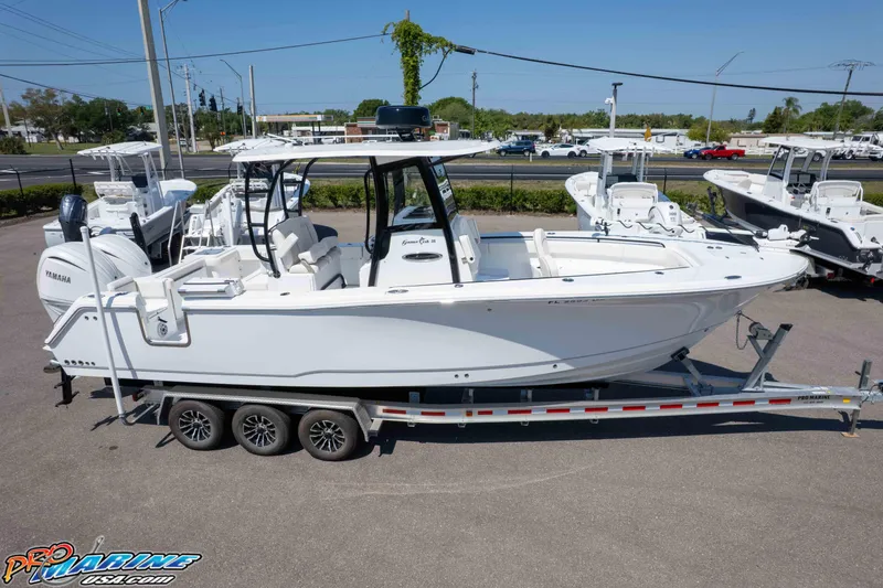 Slide: The Image of 2025 Sea Hunt Gamefish 28 Forward Seating boat on trailer, displayed outdoors. - 30