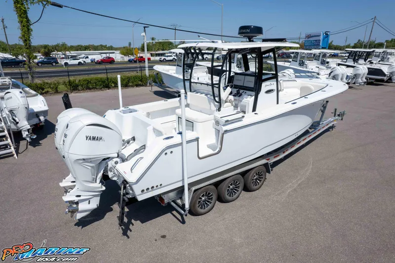 Slide: The Image of 2025 Sea Hunt Gamefish 28 Forward Seating boat on trailer, featuring Yamaha outboard engines. - 33