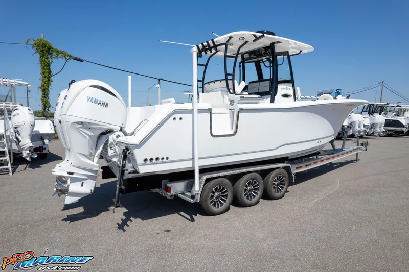 Slide: The Image of 2025 Sea Hunt Gamefish 28 boat on trailer, featuring Yamaha outboard engine. - 34