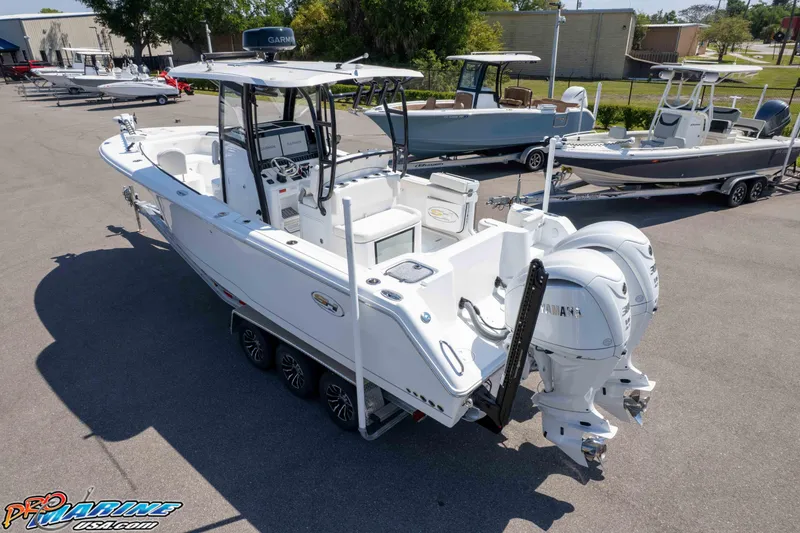 Slide: The Image of 2025 Sea Hunt Gamefish 28 boat with dual Yamaha engines in a marina setting. - 37