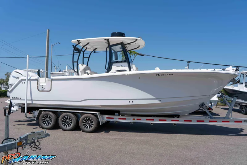 Slide: The Image of 2025 Sea Hunt Gamefish 28 boat on trailer, side view, sunny day. - 4
