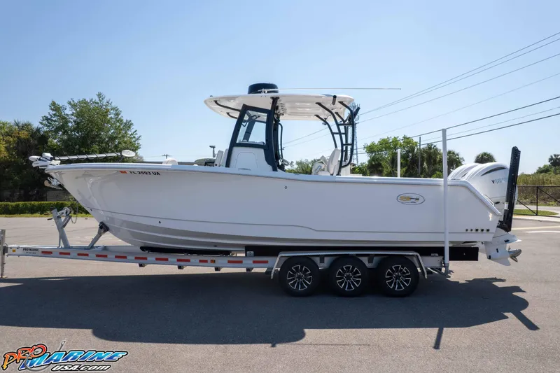 Slide: The Image of 2025 Sea Hunt Gamefish 28 boat on trailer, side view, outdoors. - 40