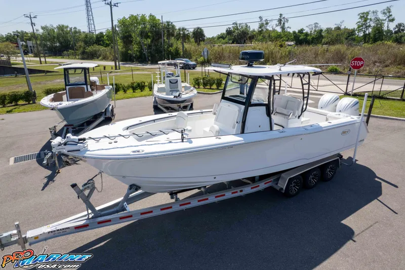 Slide: The Image of 2025 Sea Hunt Gamefish 28 Forward Seating boat on trailer, parked outdoors. - 41