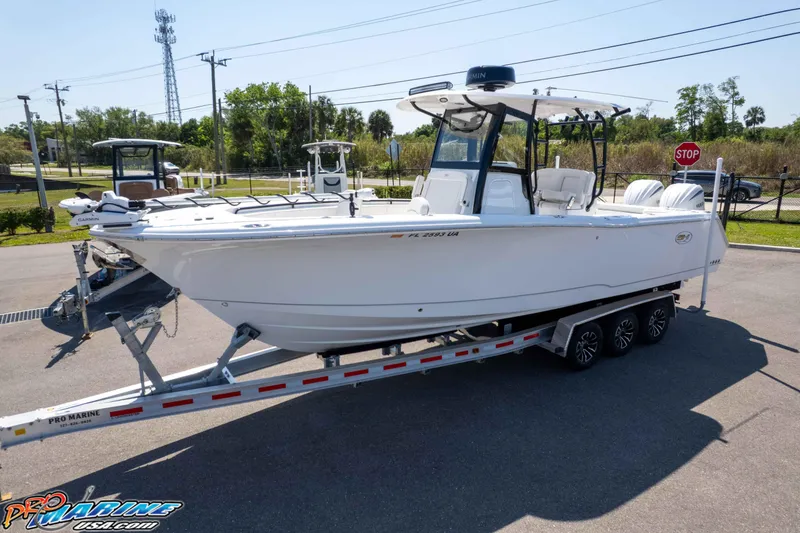 Slide: The Image of 2025 Sea Hunt Gamefish 28 Forward Seating boat on trailer in outdoor setting. - 42