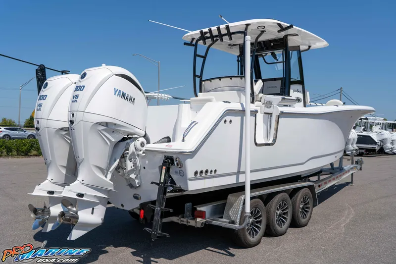 Slide: The Image of 2025 Sea Hunt Gamefish 28 boat with twin Yamaha engines on a trailer. - 5