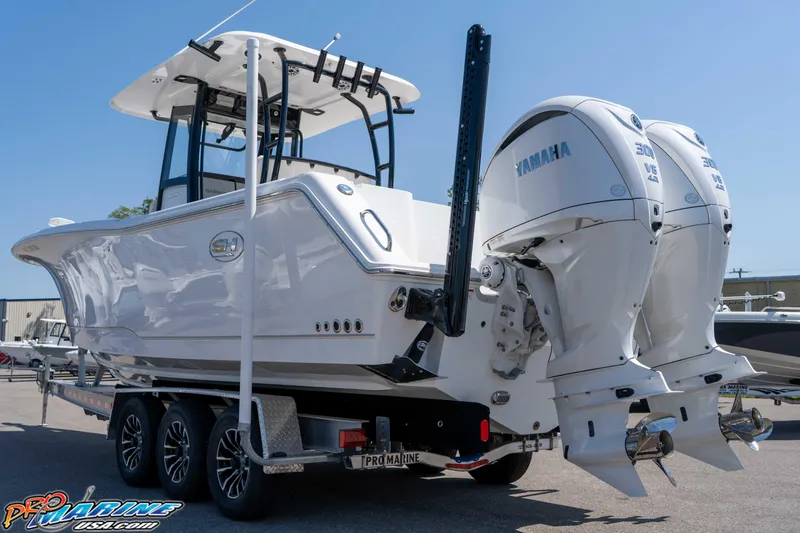 Slide: The Image of 2025 Sea Hunt Gamefish 28 boat with dual Yamaha engines on a trailer. - 8