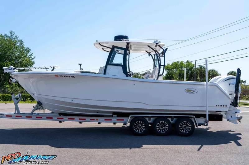 Slide: The Image of 2025 Sea Hunt Gamefish 28 Forward Seating boat on trailer, side view. - 9