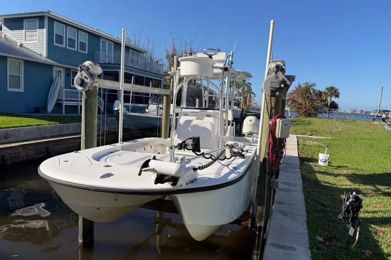 The Image of 2020 Tideline 235 Hybrid boat docked near a waterfront home. - 1