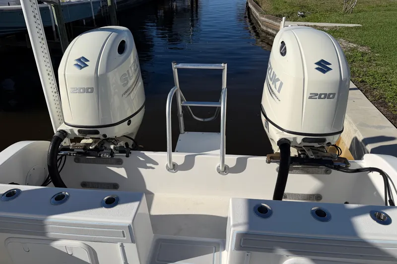 Slide: The Image of 2020 Tideline 235 Hybrid boat with dual Suzuki 200 outboard engines at dock. - 10