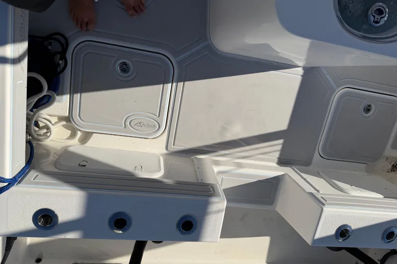 Slide: The Image of 2020 Tideline 235 Hybrid boat deck with storage compartments and fishing rod holders. - 12