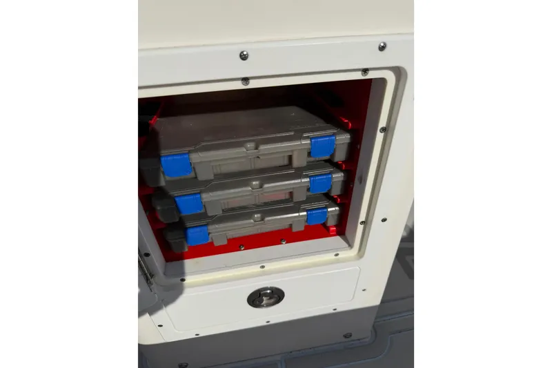 Slide: The Image of Storage compartment with tackle boxes on a 2020 Tideline 235 Hybrid boat. - 14