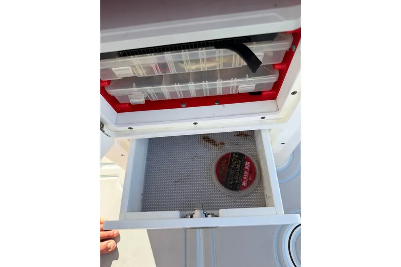 Slide: The Image of Tackle storage on 2020 Tideline 235 Hybrid boat with organized compartments. - 18