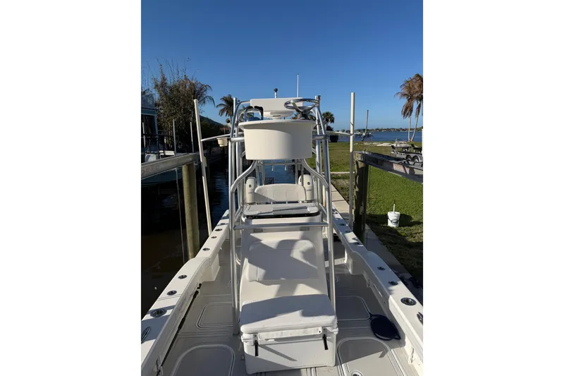 Slide: The Image of 2020 Tideline 235 Hybrid boat docked, showcasing sleek design and spacious deck. - 23