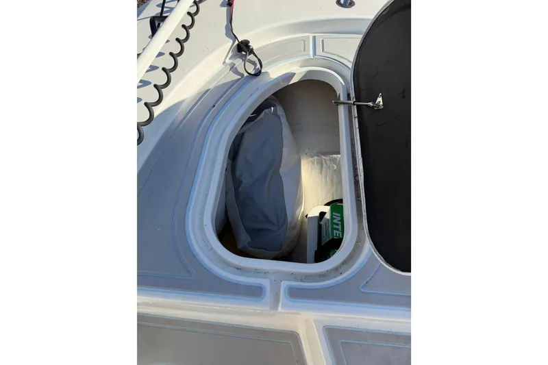 Slide: The Image of Open storage compartment on 2020 Tideline 235 Hybrid boat deck. - 25