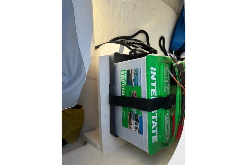 Slide: The Image of Battery compartment in a 2020 Tideline 235 Hybrid boat, featuring an Interstate deep cycle battery. - 26