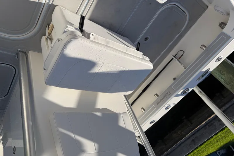 Slide: The Image of 2020 Tideline 235 Hybrid boat interior with white seating and storage compartments. - 28