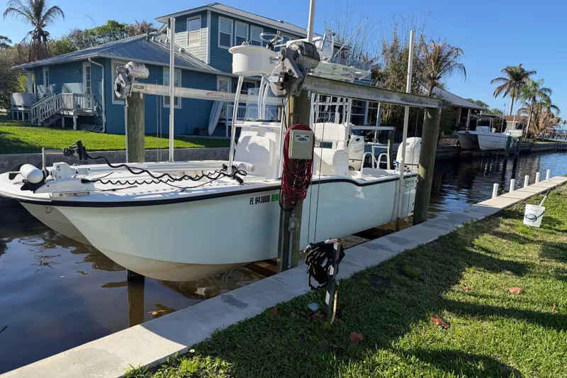 Slide: The Image of 2020 Tideline 235 Hybrid boat docked near waterfront homes, sunny day. - 3