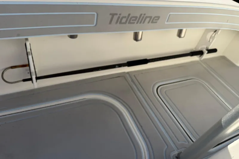 Slide: The Image of 2020 Tideline 235 Hybrid boat interior with storage compartments and rod holder. - 31