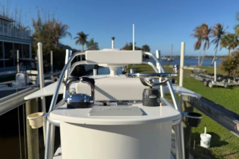 Slide: The Image of 2020 Tideline 235 Hybrid boat docked near palm trees and waterfront. - 32