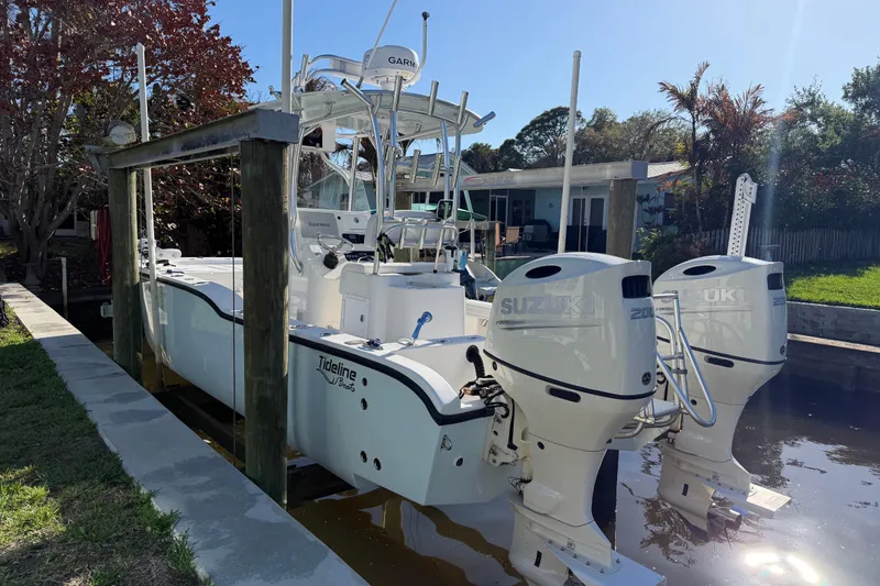 Slide: The Image of 2020 Tideline 235 Hybrid boat docked with twin Suzuki engines. - 4
