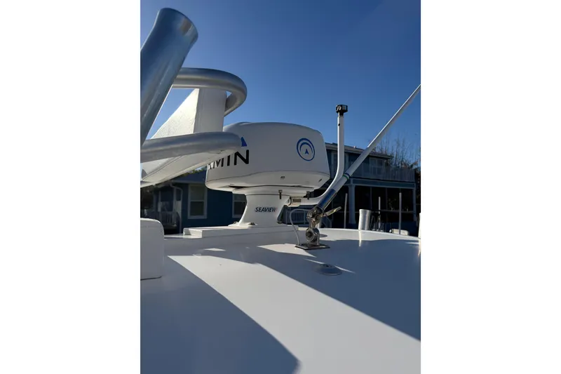 Slide: The Image of 2020 Tideline 235 Hybrid boat with Garmin radar and antenna, under clear blue sky. - 40