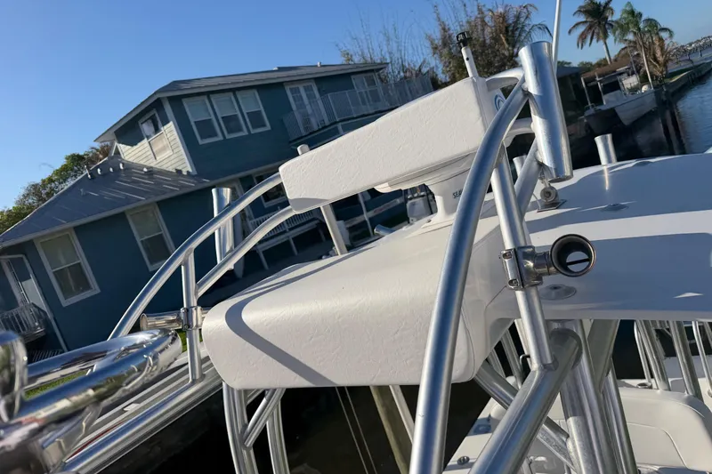 Slide: The Image of 2020 Tideline 235 Hybrid boat with sleek metal railings, docked near waterfront homes. - 41