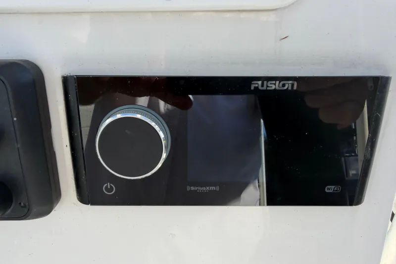 Slide: The Image of Fusion audio system on Tideline 235 Hybrid boat, 2020 model, featuring SiriusXM and WiFi connectivity. - 46