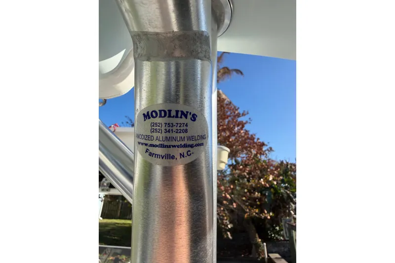 Slide: The Image of Sticker on Tideline 235 Hybrid boat, featuring Modlin's anodized aluminum welding services. - 53