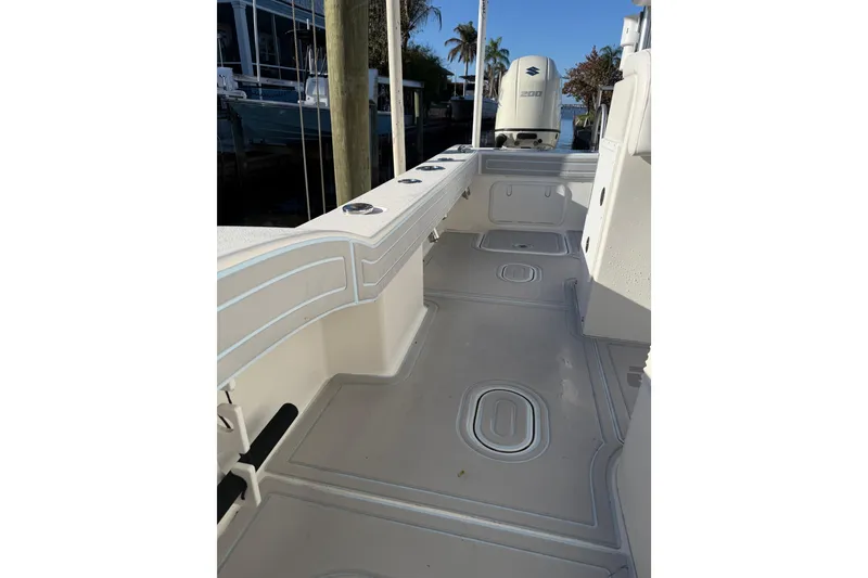 Slide: The Image of 2020 Tideline 235 Hybrid boat interior with clean deck and Suzuki outboard motor. - 54