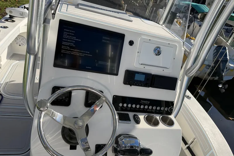 Slide: The Image of 2020 Tideline 235 Hybrid boat dashboard with steering wheel and navigation display. - 56
