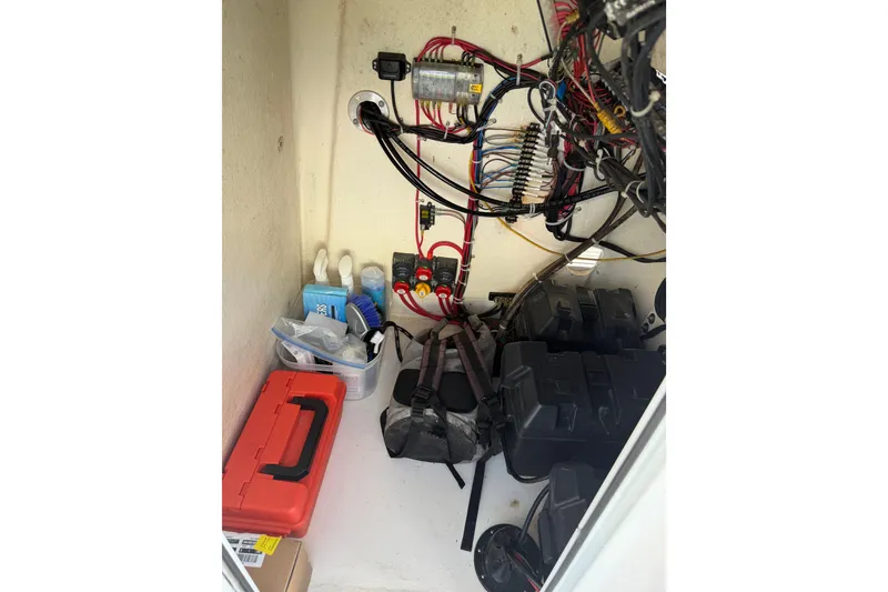 Slide: The Image of Electrical compartment of 2020 Tideline 235 Hybrid boat with wiring and storage. - 57