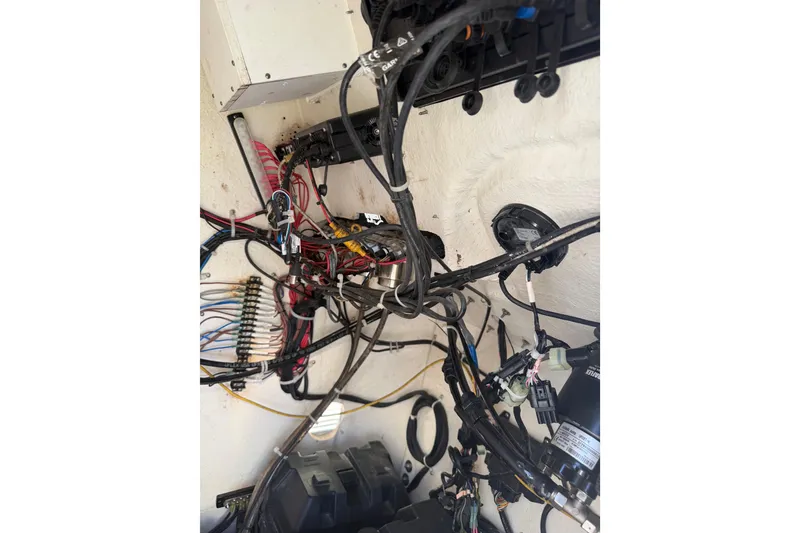 Slide: The Image of Electrical wiring inside a 2020 Tideline 235 Hybrid boat, showcasing complex connections. - 58