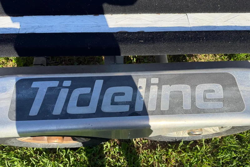 Slide: The Image of Close-up of Tideline 235 Hybrid 2020 logo on a boat trailer. - 64