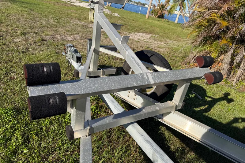 Slide: The Image of Boat trailer for 2020 Tideline 235 Hybrid on grassy shore near water. - 65