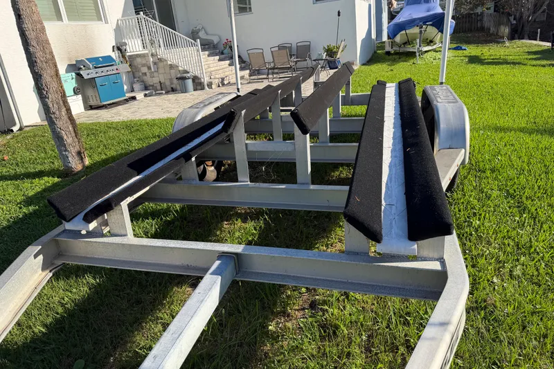 Slide: The Image of Boat trailer for 2020 Tideline 235 Hybrid on grass near patio and grill. - 66