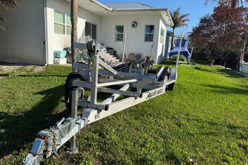 Slide: The Image of Boat trailer on grass beside house, Tideline 235 Hybrid, 2020 model. - 67