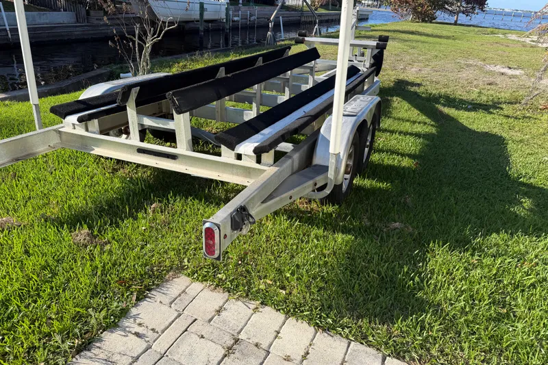 Slide: The Image of Boat trailer on grass near water, designed for Tideline 235 Hybrid, 2020 model. - 70